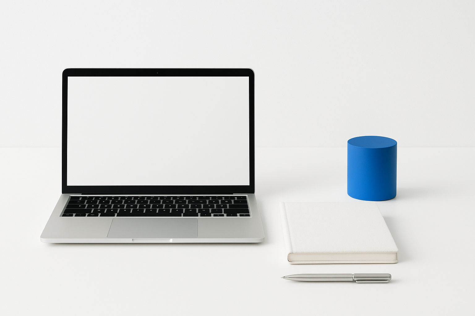 A bright studio still life on a white seamless surface with a laptop, notebook, pen, and one saturated blue accent object arranged in a minimal composition.