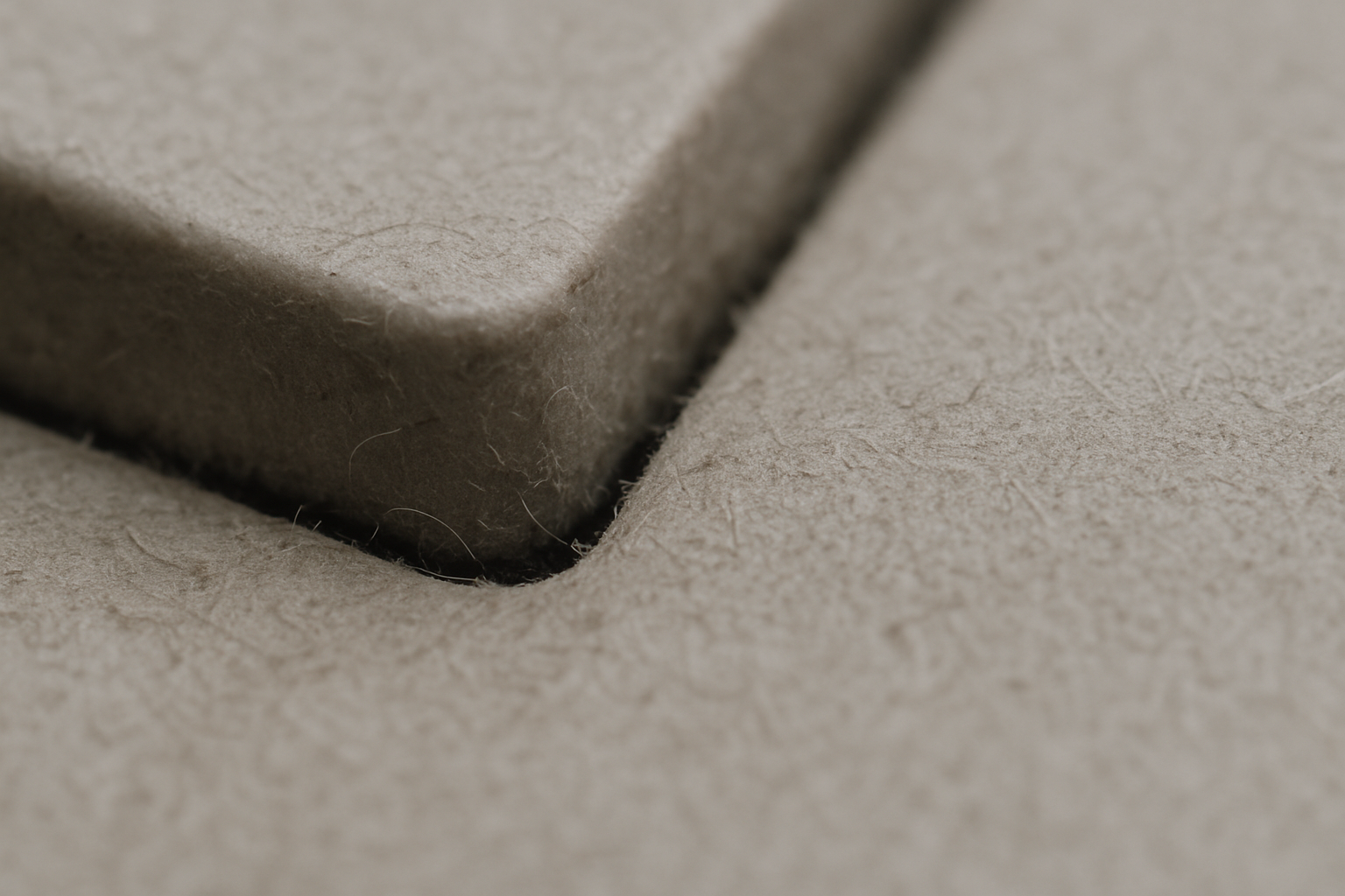 A tightly cropped macro view of a worn keyboard edge under soft, desaturated light.