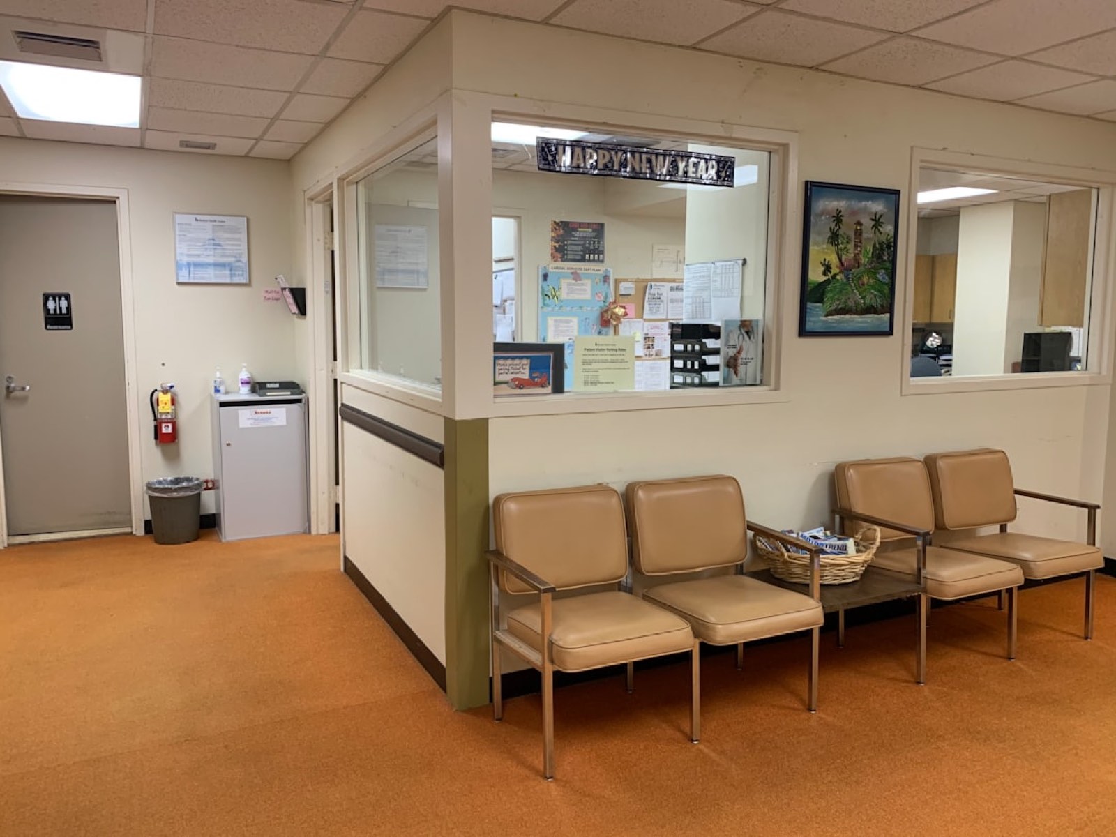A hospital registration desk with patients checking in
